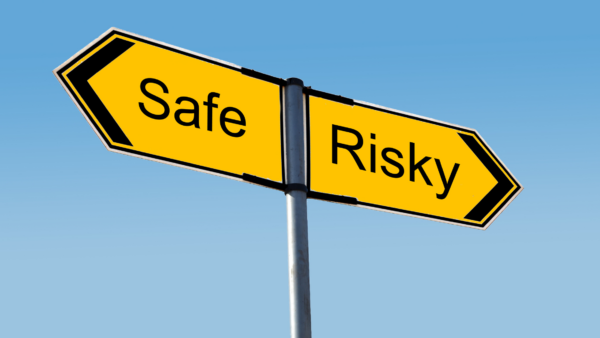 Sign pointing in a safe direction and a risky direction