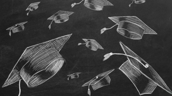 Graduation hats sketched on chalkboard