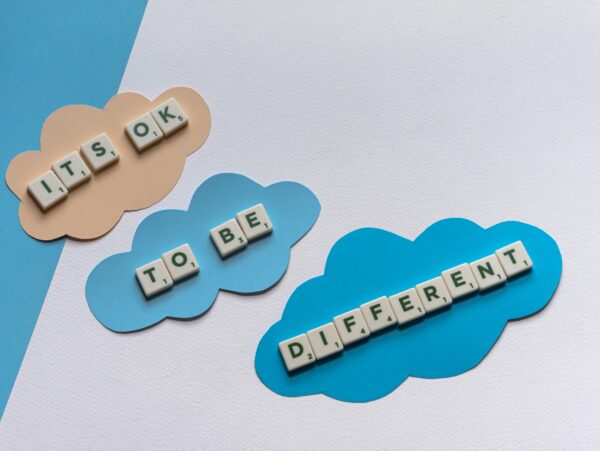 Scrabble Tiles on the Table that say "It's ok to be different"